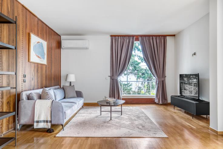 Elegantly designed living room with modern furnishings in an apartment at 492fbdeb-5707-4d10-937e-81d8e92886f6 in Psychiko, Athens