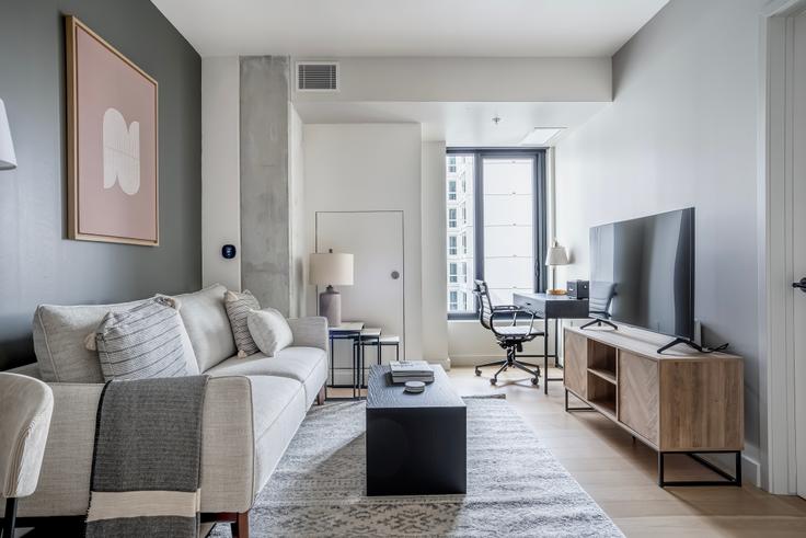 Elegantly designed living room with modern furnishings in an apartment at Chorus in Hayes Valley, San Francisco Bay Area