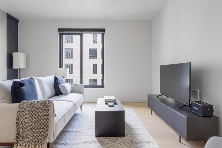 Elegantly designed living room with modern furnishings in an apartment at Chorus in Hayes Valley, San Francisco Bay Area