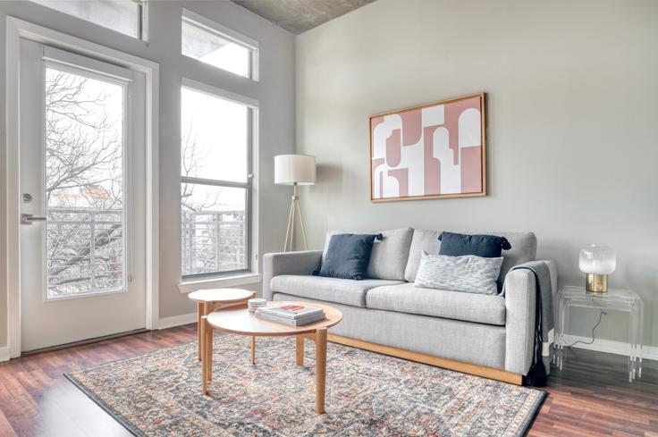 Elegantly designed living room with modern furnishings in an apartment at Coldwater in Zilker, Austin