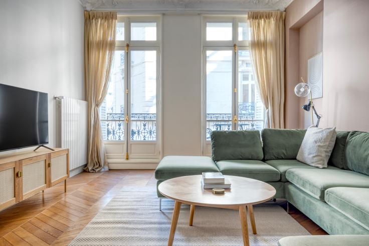 Elegantly designed living room with modern furnishings in an apartment at Arsène Houssaye 6 in Champs-Élysées, Paris