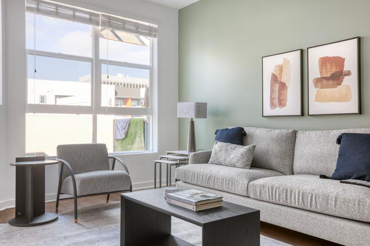 Elegantly designed living room with modern furnishings in an apartment at Metro Mission Valley in Mission Valley, San Diego