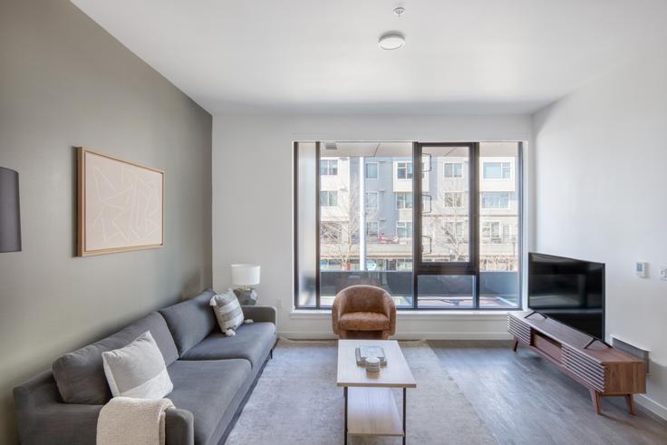 Elegantly designed living room with modern furnishings in an apartment at Jackson in Central District, Seattle