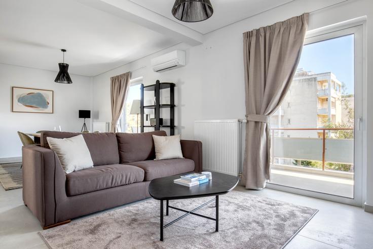 Elegantly designed living room with modern furnishings in an apartment at 6c7caddf-78ff-44e8-8343-155c51b79328 in Agia Paraskevi, Athens