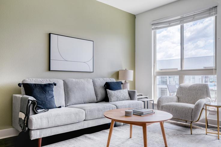 Elegantly designed living room with modern furnishings in an apartment at Vora Mission Valley - 6161 in Mission Valley, San Diego