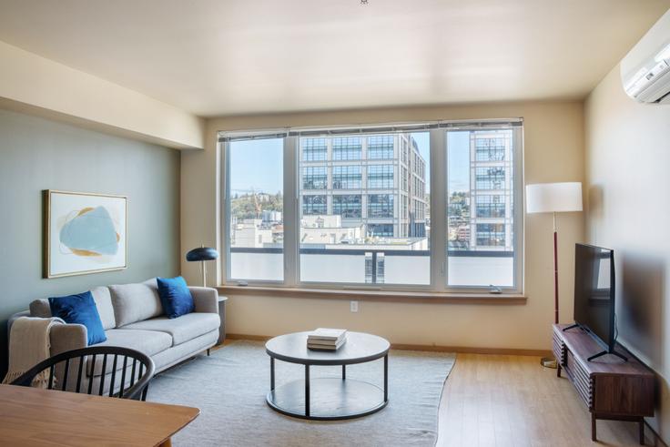 Elegantly designed living room with modern furnishings in an apartment at 708 Uptown in Lower Queen Anne, Seattle