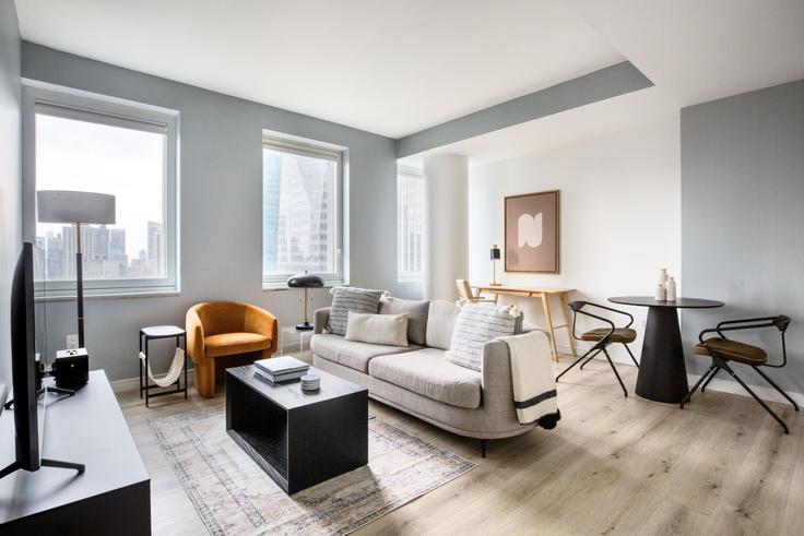 Elegantly designed living room with modern furnishings in an apartment at Cassa in Midtown, New York