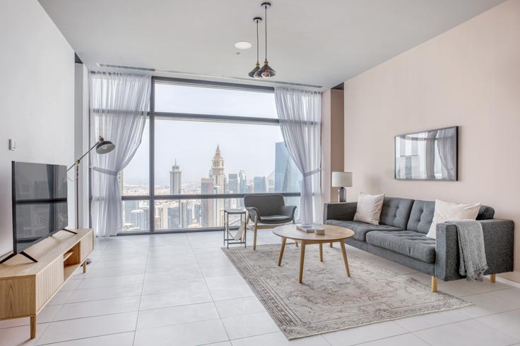 Chic living room with minimalist design from a furnished apartment in Index Tower, Dubai