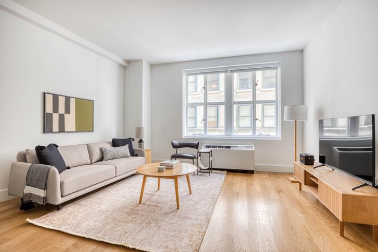 Elegantly designed living room with modern furnishings in an apartment at 63 Wall Street in Financial District, New York