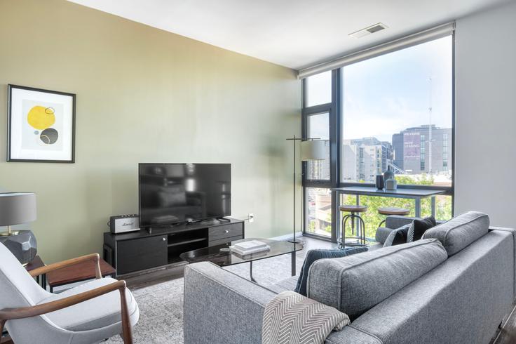 Elegantly designed living room with modern furnishings in an apartment at The Shay - West in Shaw, Washington D.C.