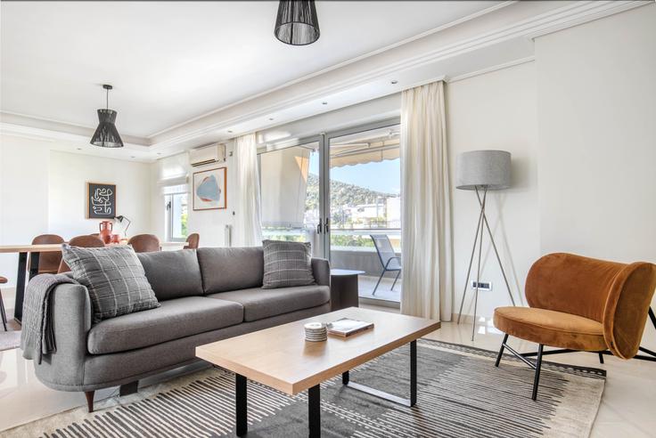 Elegantly designed living room with modern furnishings in an apartment at 1a5caa01-4159-4bd8-af4d-9446134f602e in Agia Paraskevi, Athens