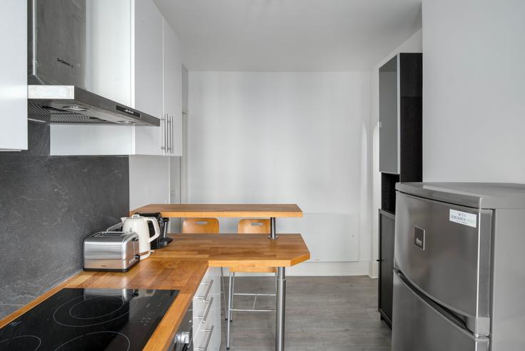 Functional and stylish kitchen with top-of-the-line equipment in an upscale apartment at Delta 12 in 9th arrondissement, Paris