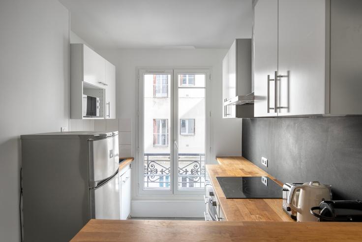 Functional and stylish kitchen with top-of-the-line equipment in an upscale apartment at Delta 12 in 9th arrondissement, Paris