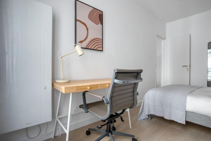 Office area with a stylish desk and a supportive chair in an apartment at Delta 12 in 9th arrondissement, Paris