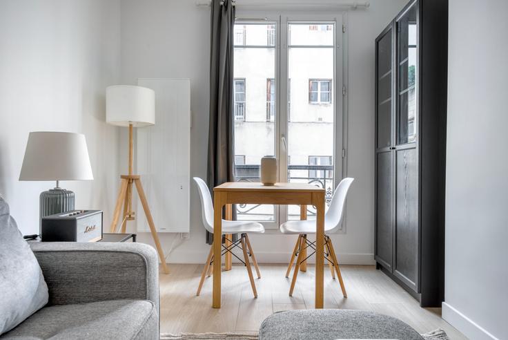 Dining table with stylish chairs in an apartment at Delta 12 in 9th arrondissement, Paris
