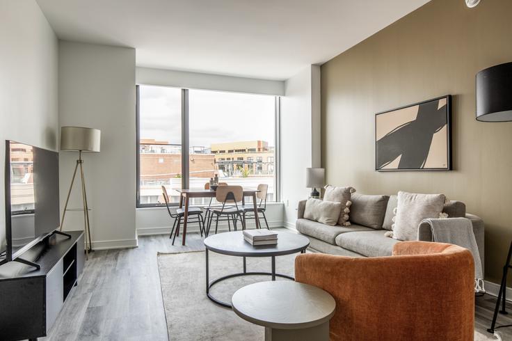 Elegantly designed living room with modern furnishings in an apartment at Crossing in Navy Yard, Washington D.C.