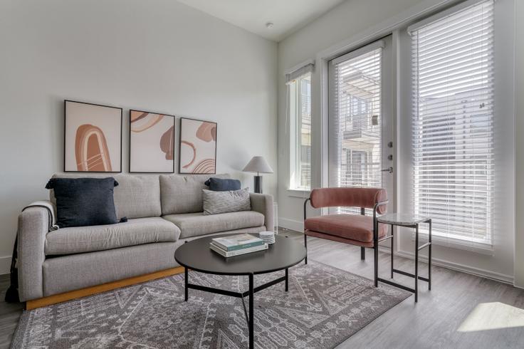 Elegantly designed living room with modern furnishings in an apartment at Medina Highlands in Highland, Austin