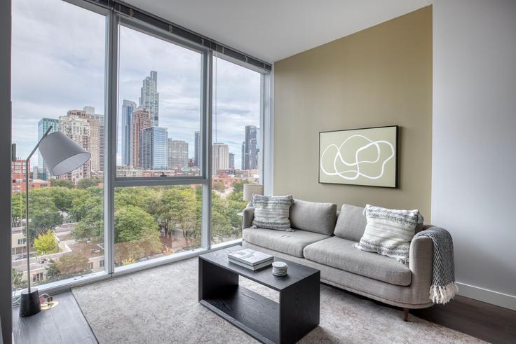 Elegantly designed living room with modern furnishings in an apartment at 1000 S Clark in South Loop, Chicago