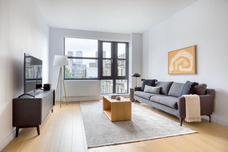 Elegantly designed living room with modern furnishings in an apartment at Sioné in Lower East Side, New York