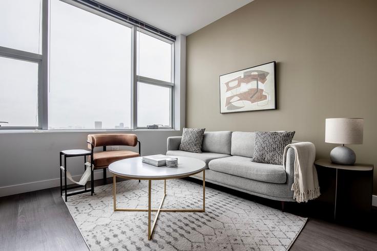 Elegantly designed living room with modern furnishings in an apartment at 1000 S Clark in South Loop, Chicago