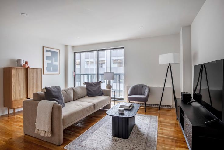 Elegantly designed living room with modern furnishings in an apartment at 123 E 54th in Midtown East, New York