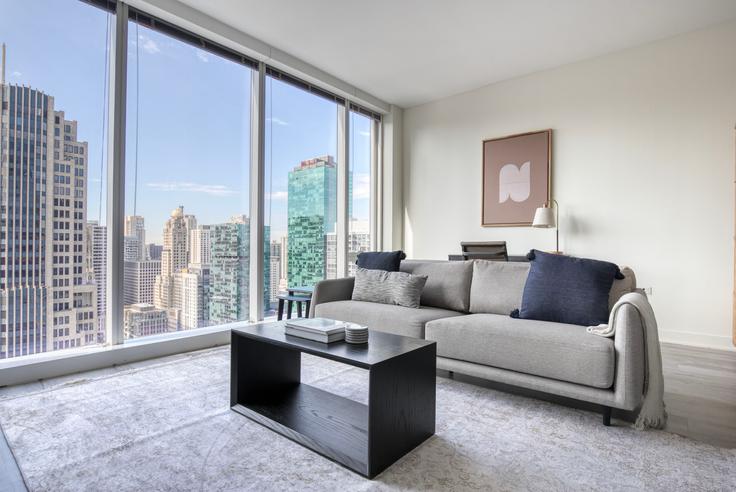 Elegantly designed living room with modern furnishings in an apartment at North Water in Streeterville, Chicago