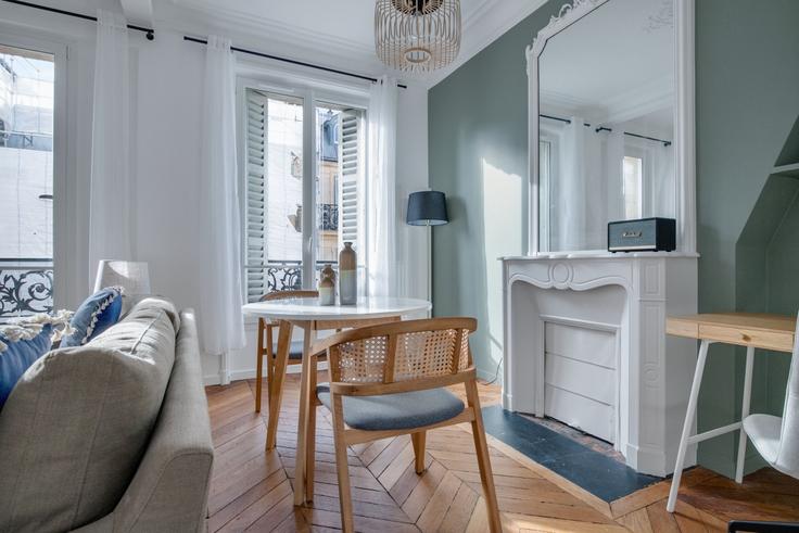 Dining table with stylish chairs in an apartment at Maubeuge 82 in 9th arrondissement, Paris