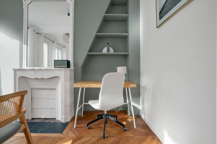 Office area with a stylish desk and a supportive chair in an apartment at Maubeuge 82 in 9th arrondissement, Paris