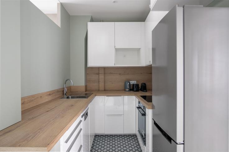 Functional and stylish kitchen with top-of-the-line equipment in an upscale apartment at Maubeuge 82 in 9th arrondissement, Paris
