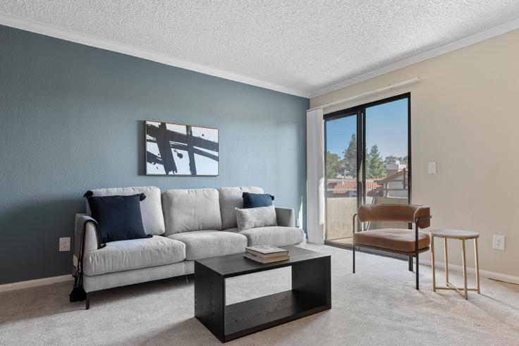 Elegantly designed living room with modern furnishings in an apartment at Eaves Rancho Penasquitos - 10022 Paseo Montril in Rancho Peñasquitos, San Diego