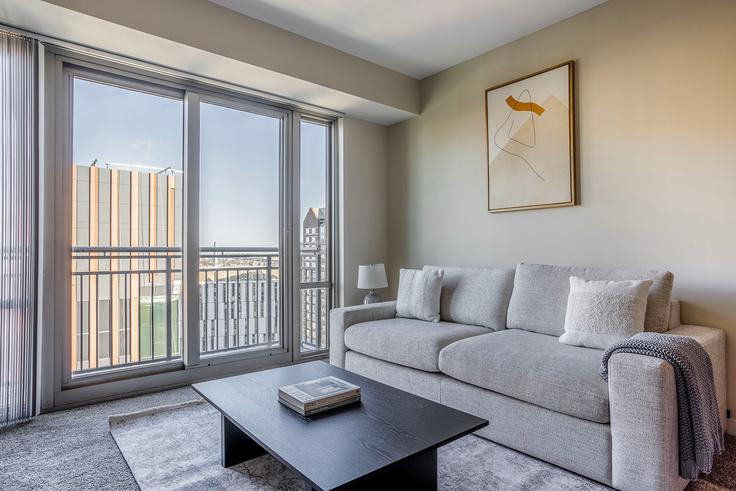 Elegantly designed living room with modern furnishings in an apartment at Elevate in East Cambridge, Boston