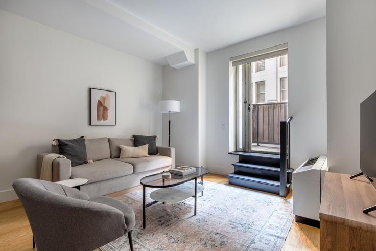 Elegantly designed living room with modern furnishings in an apartment at 63 Wall Street in Financial District, New York