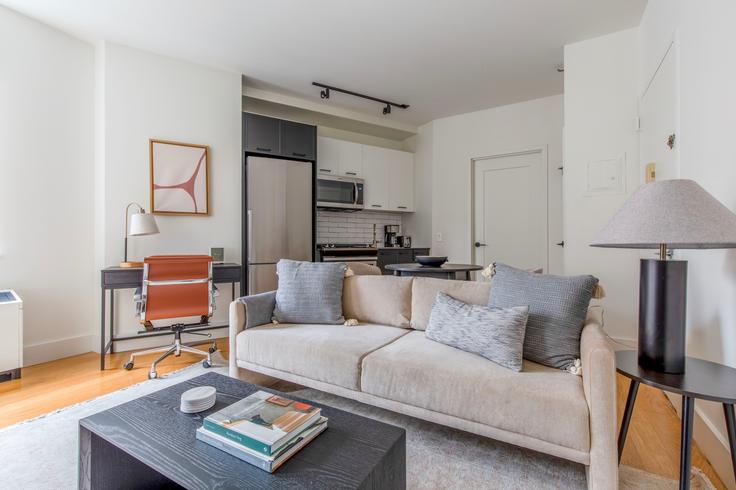 Elegantly designed living room with modern furnishings in an apartment at 63 Wall Street in Financial District, New York