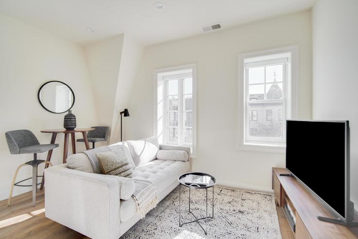 Elegantly designed living room with modern furnishings in an apartment at 1701 21st St NW in Dupont Circle, Washington D.C.