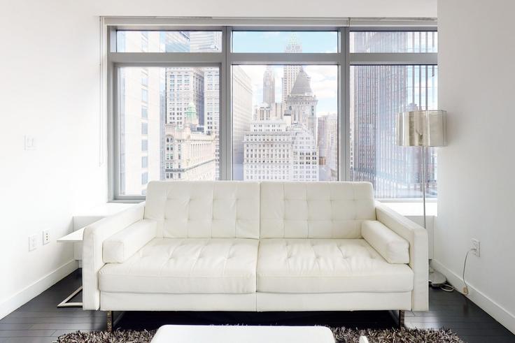 Elegantly designed living room with modern furnishings in an apartment at W Residences at 123 Washington in Financial District, New York