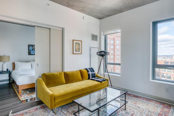 Elegantly designed living room with modern furnishings in an apartment at Proto in Kendall Square, Boston