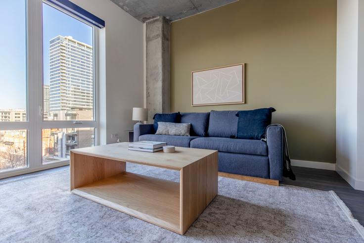 Elegantly designed living room with modern furnishings in an apartment at Hugo in River North, Chicago