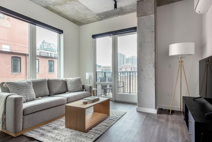 Elegantly designed living room with modern furnishings in an apartment at Hugo in River North, Chicago