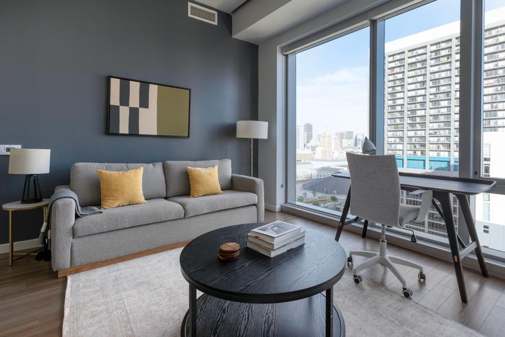 Elegantly designed living room with modern furnishings in an apartment at 100 Van Ness in Hayes Valley, San Francisco Bay Area