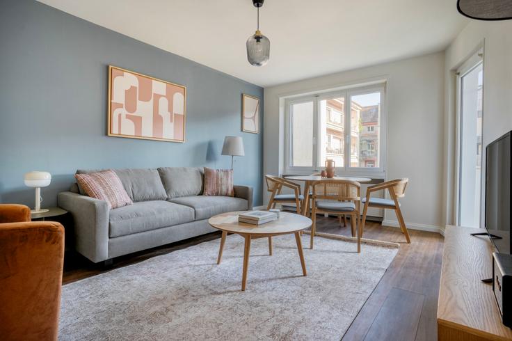 Elegantly designed living room with modern furnishings in an apartment at Häsingerstrasse 29 in Iselin, Basel