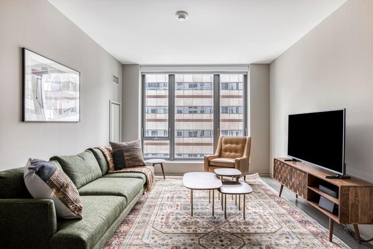 Elegantly designed living room with modern furnishings in an apartment at Avalon North Station in North Station, Boston