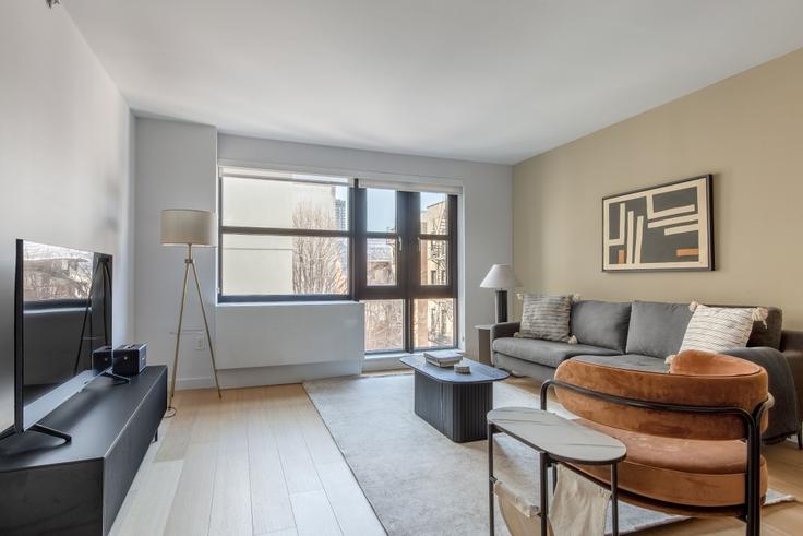 Elegantly designed living room with modern furnishings in an apartment at Sioné in Lower East Side, New York