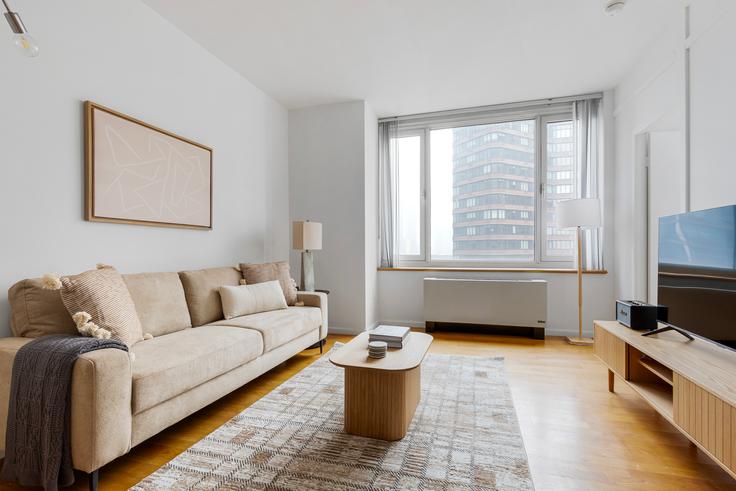 Elegantly designed living room with modern furnishings in an apartment at Atelier in Midtown West, New York