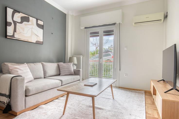 Chic living room with minimalist design from a furnished apartment in Palaio Faliro, Athens