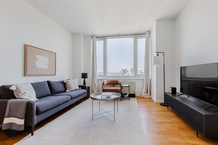 Elegantly designed living room with modern furnishings in an apartment at Atelier in Midtown West, New York