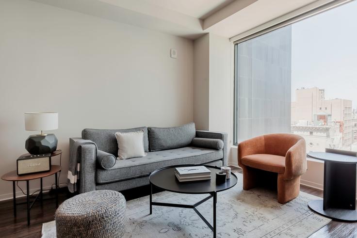 Elegantly designed living room with modern furnishings in an apartment at LUKA on the Common in Theater District / Chinatown, Boston