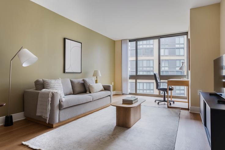 Elegantly designed living room with modern furnishings in an apartment at Meridian at Mt Vernon Triangle Phase 2 in Mount Vernon, Washington D.C.