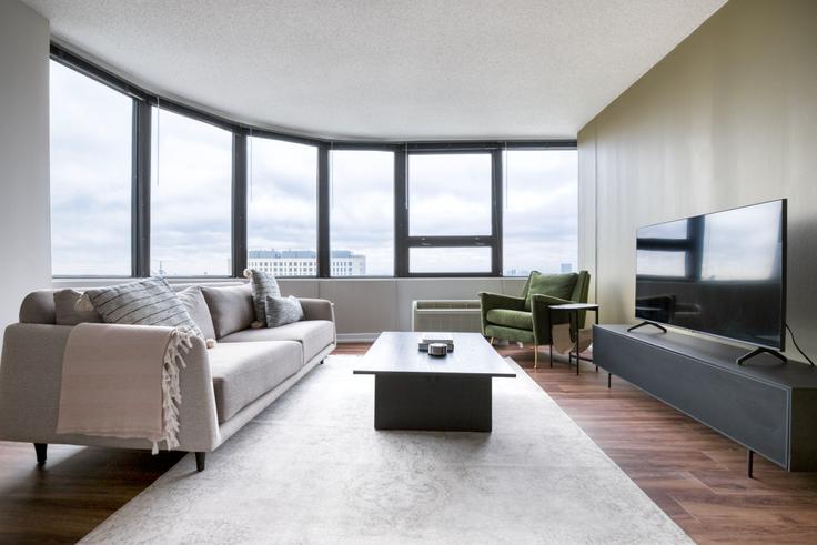 Elegantly designed living room with modern furnishings in an apartment at Park Michigan in South Loop, Chicago