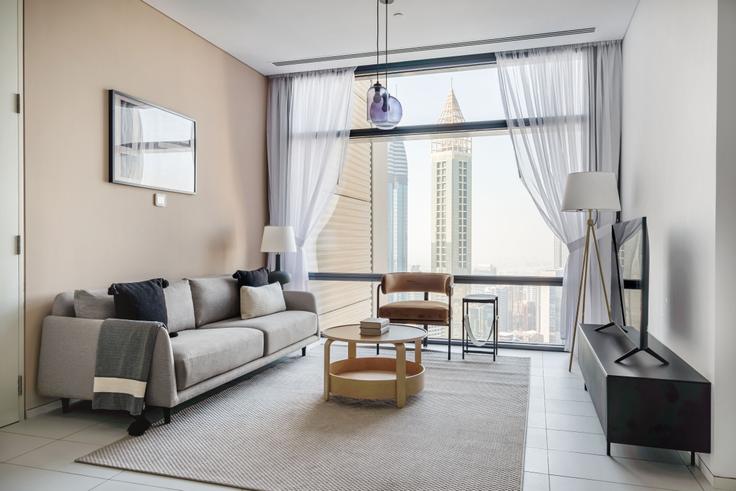 Chic living room with minimalist design from a furnished apartment in Index Tower, Dubai