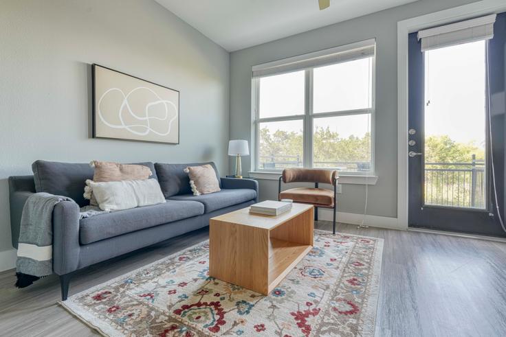 Elegantly designed living room with modern furnishings in an apartment at Camber Ranch in Lost Plains, Austin